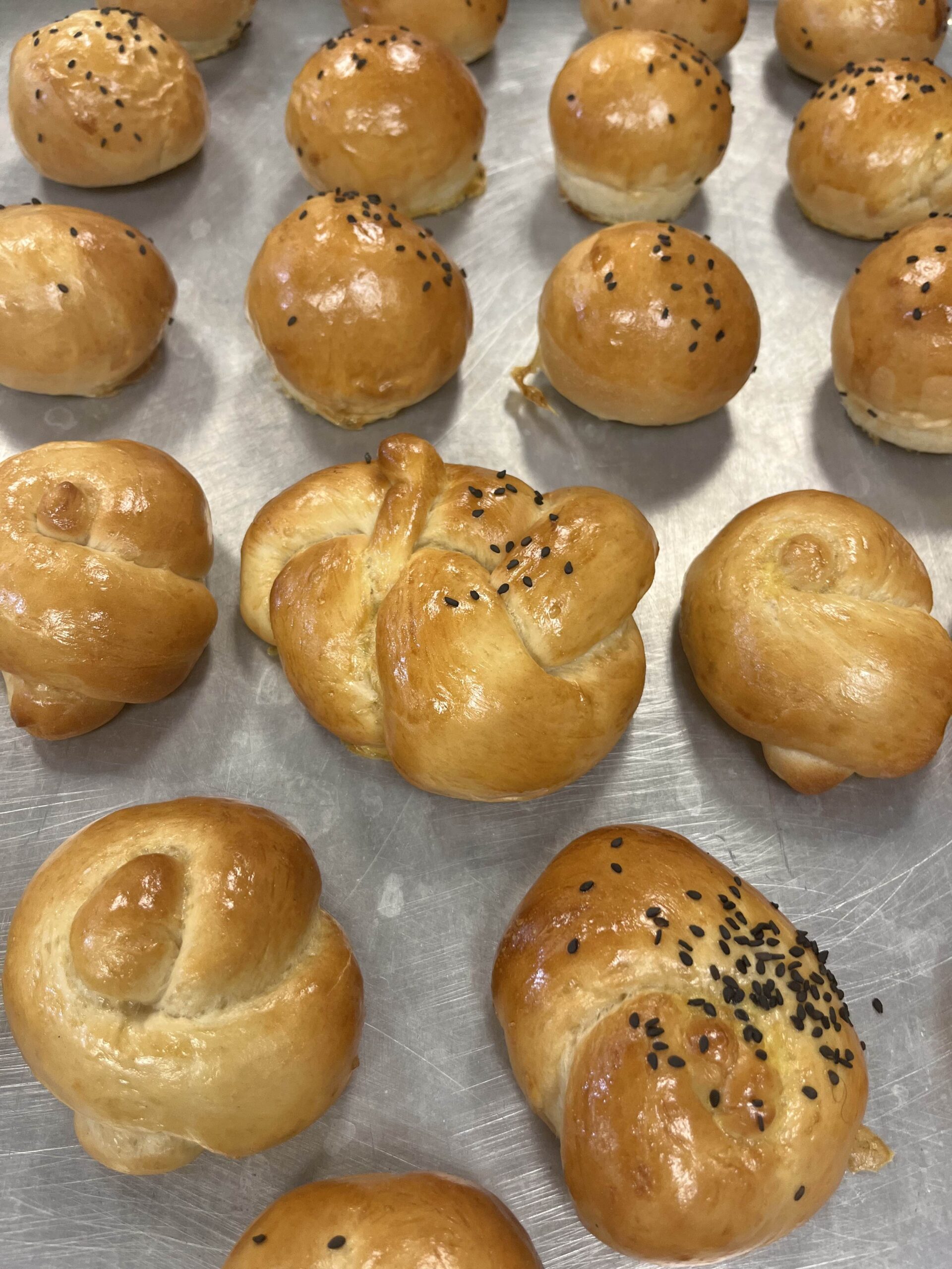 Dinner rolls variations, knots some with sesame seeds.