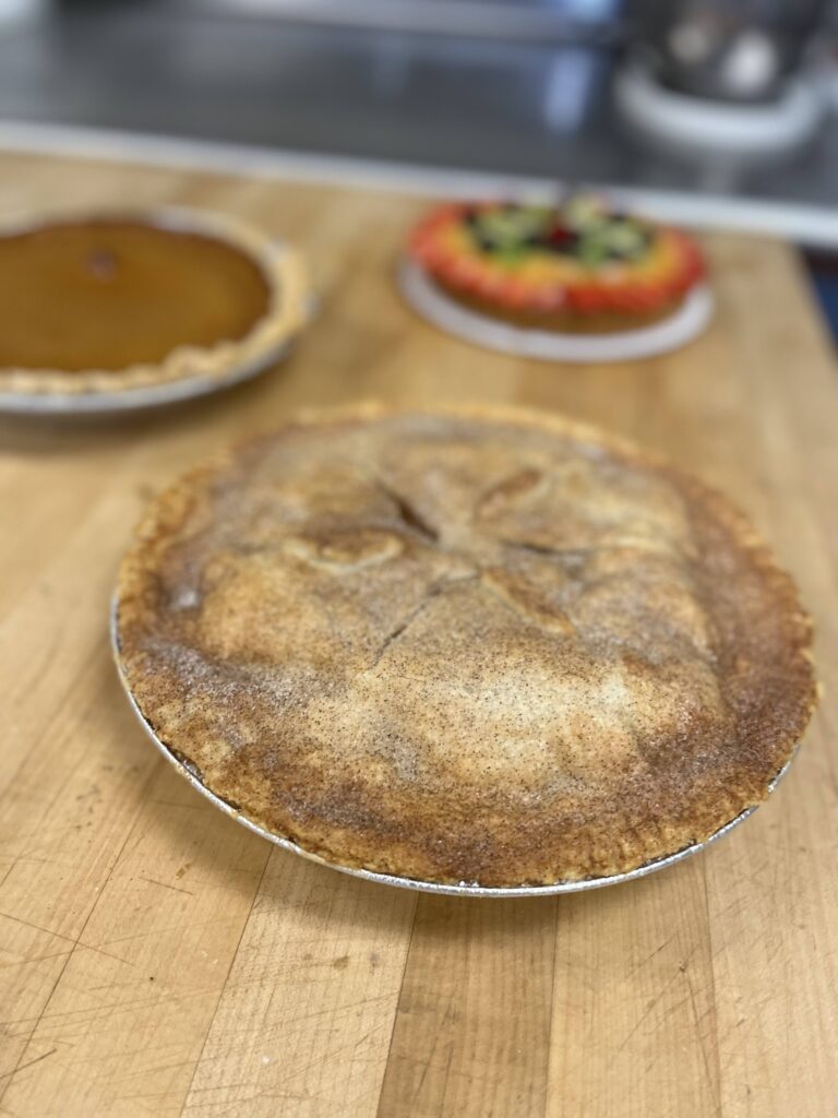 Apple Pie with Traditional Crust in the foreground.