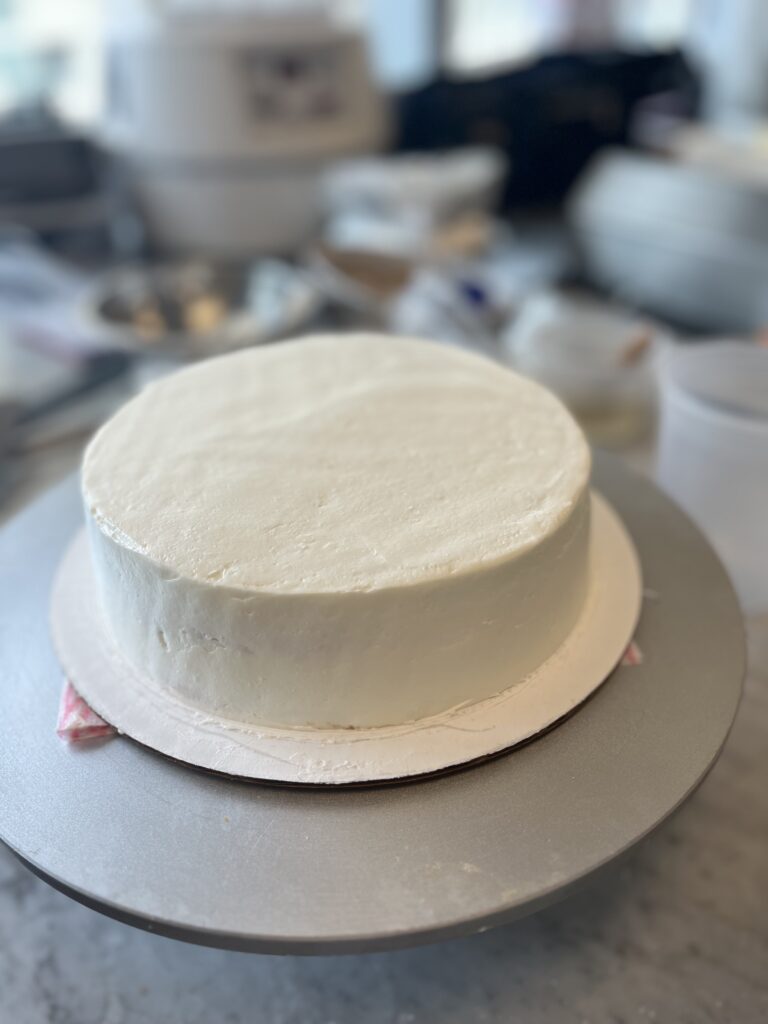 Final Smoothing of the cake surface using a heated offset spatula